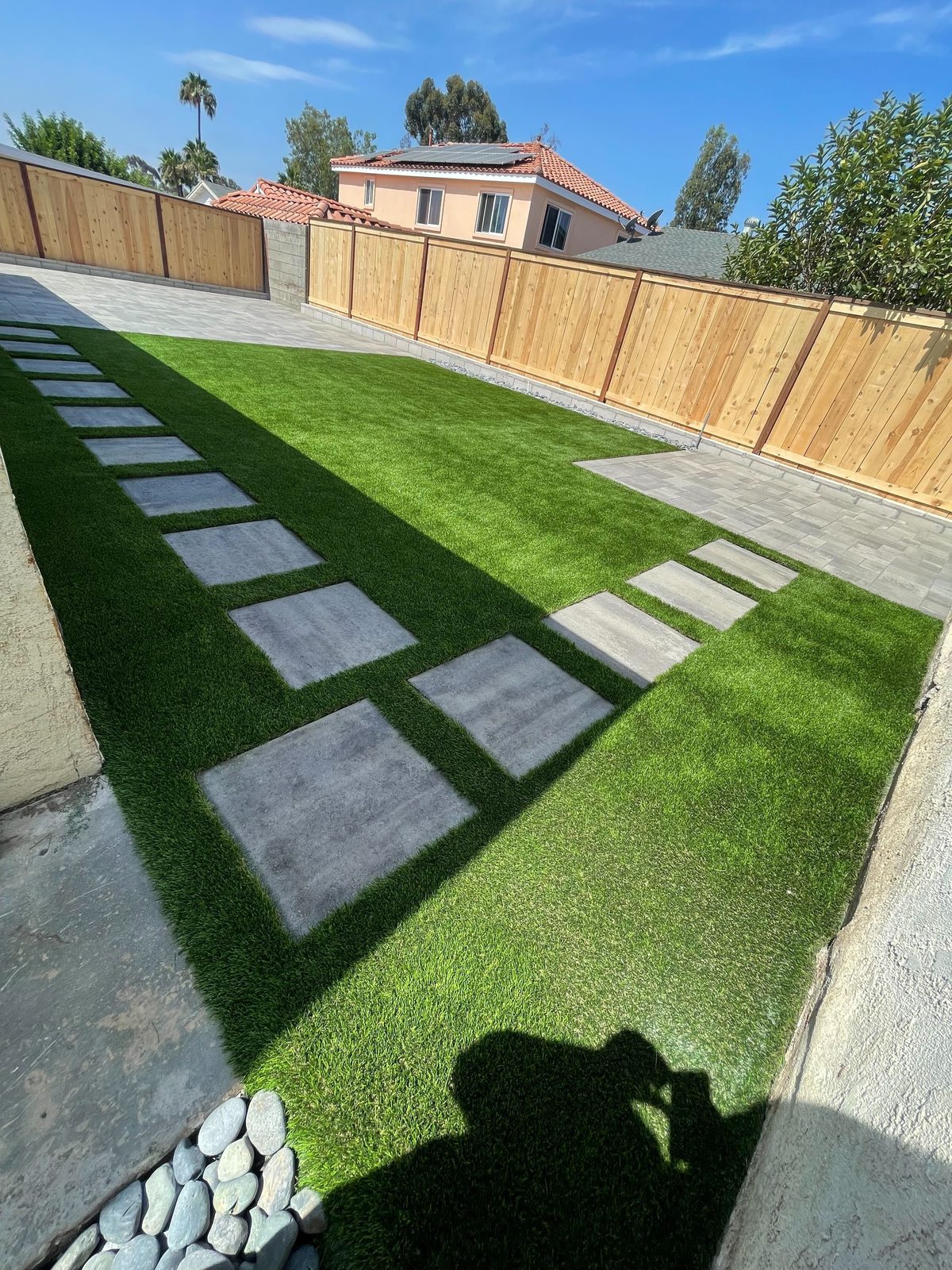 Artificial turf side yard with large paver stepping stones